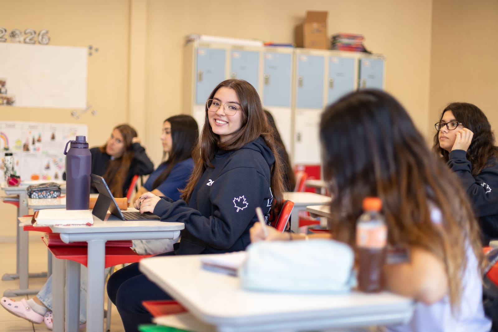 Aluna do Ensino Médio sorrindo em sala de aula da Canadian School de Niterói